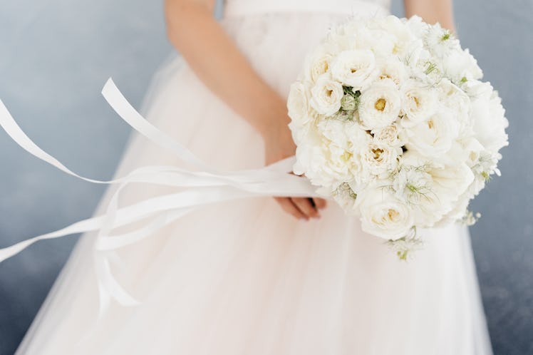 white bride's bouquet in the hands of the bride