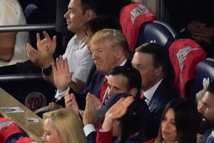 President Donald Trump watches during the first inning of Game 5 of the baseball World Series betwee...