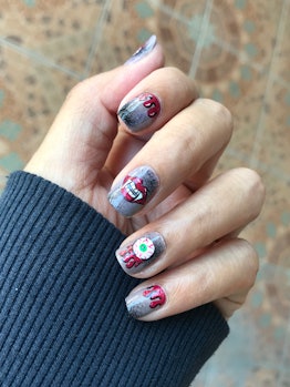 Short square-shaped nails feature designs of dripping blood, vampire fangs, and an eyeball.