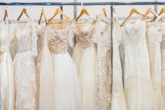 Many beautiful wedding dresses hang in the store
