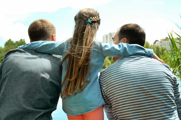 Gay couple with daughter on a pier,