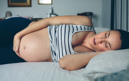 pregnant woman lying on left side, focusing on kicks