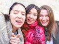  Young women taking selfie warning you - Teenage girls fun moments doing funny faces tongue out - Be...