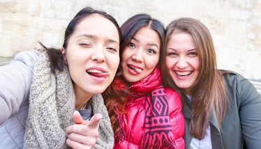  Young women taking selfie warning you - Teenage girls fun moments doing funny faces tongue out - Be...