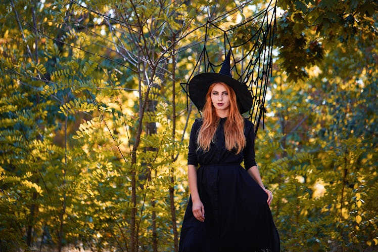 Young woman in Halloween witch costume for your Scorpio season 2019 horoscope.