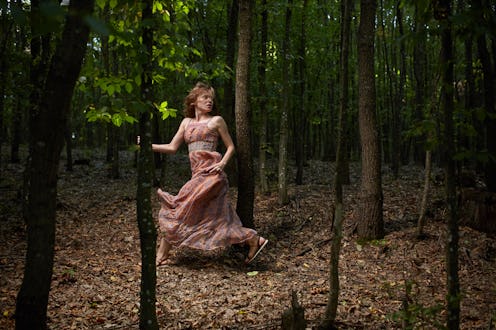 Scared woman running through the forest