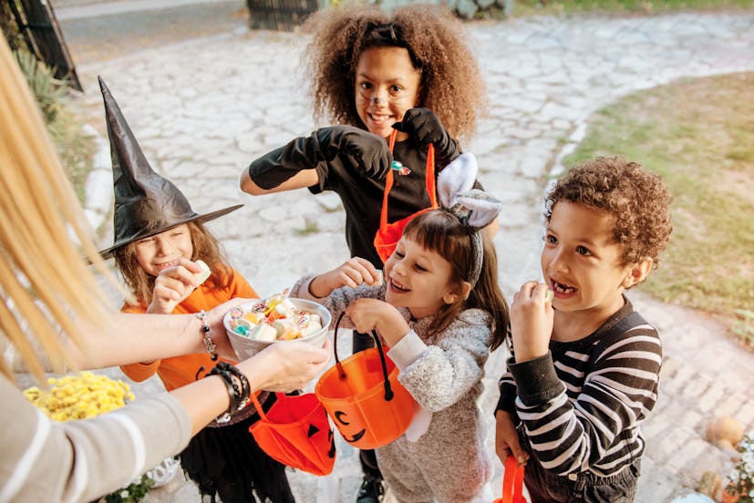 Children in Halloween costumes, trick or treating. 