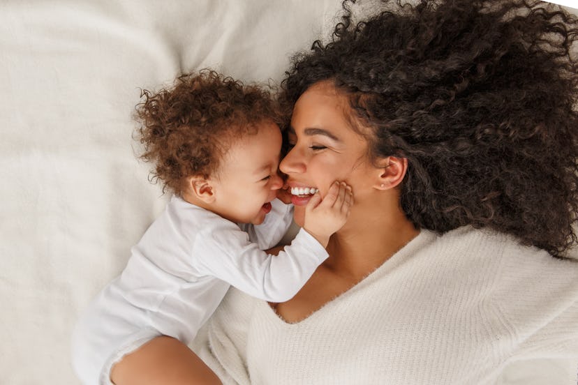 a mom and a little baby snuggling up in an article about girl names that start with "M" 