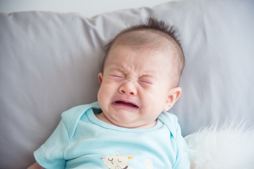 Closeup shot of little asian infant crying
