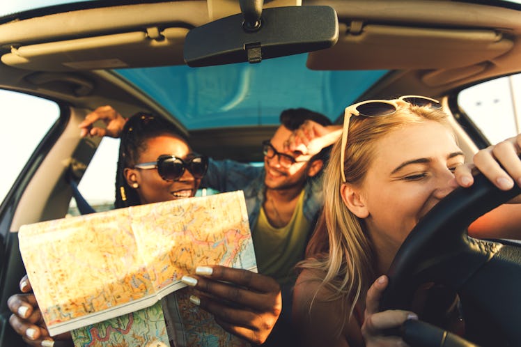 Three best friends enjoying traveling at vacation in the car.
