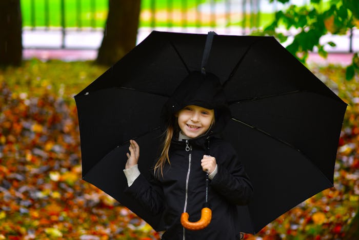 child with umbrella autumn portrait