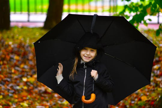 child with umbrella autumn portrait
