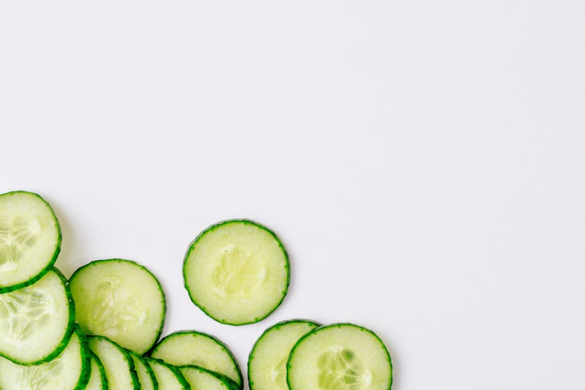 Fresh cucumber slices on a white background. Copy space.