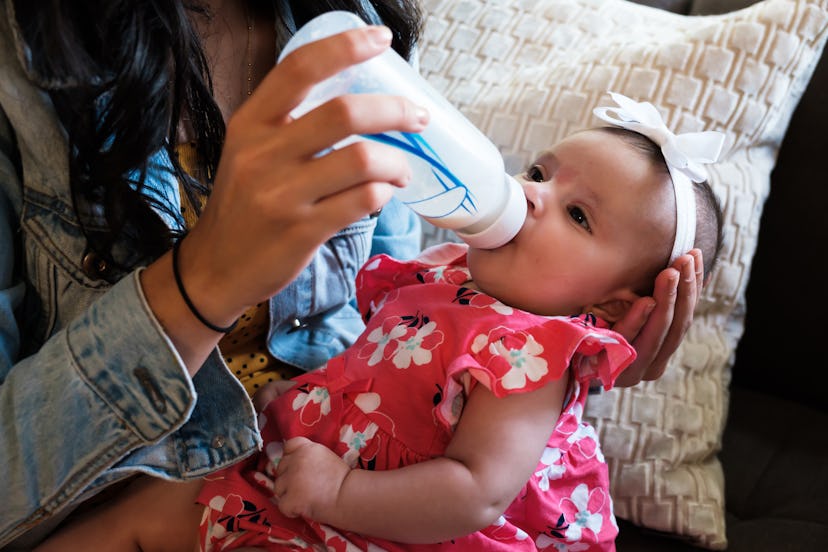 Baby being fed from a bottle.