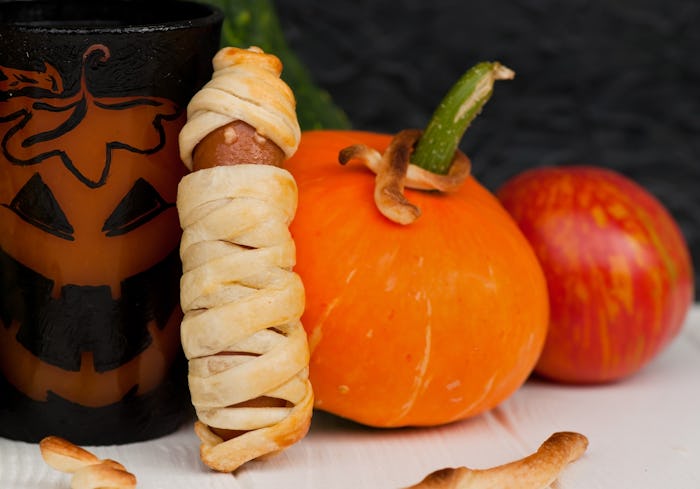 Sausages, baked in the dough, in the form of mummies. Halloween menu. Food kids. Fun food.