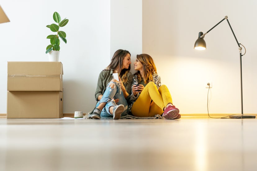 Lesbian couple making a new arrangement in apartment