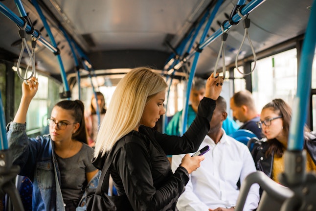Woman with phone at the public transport