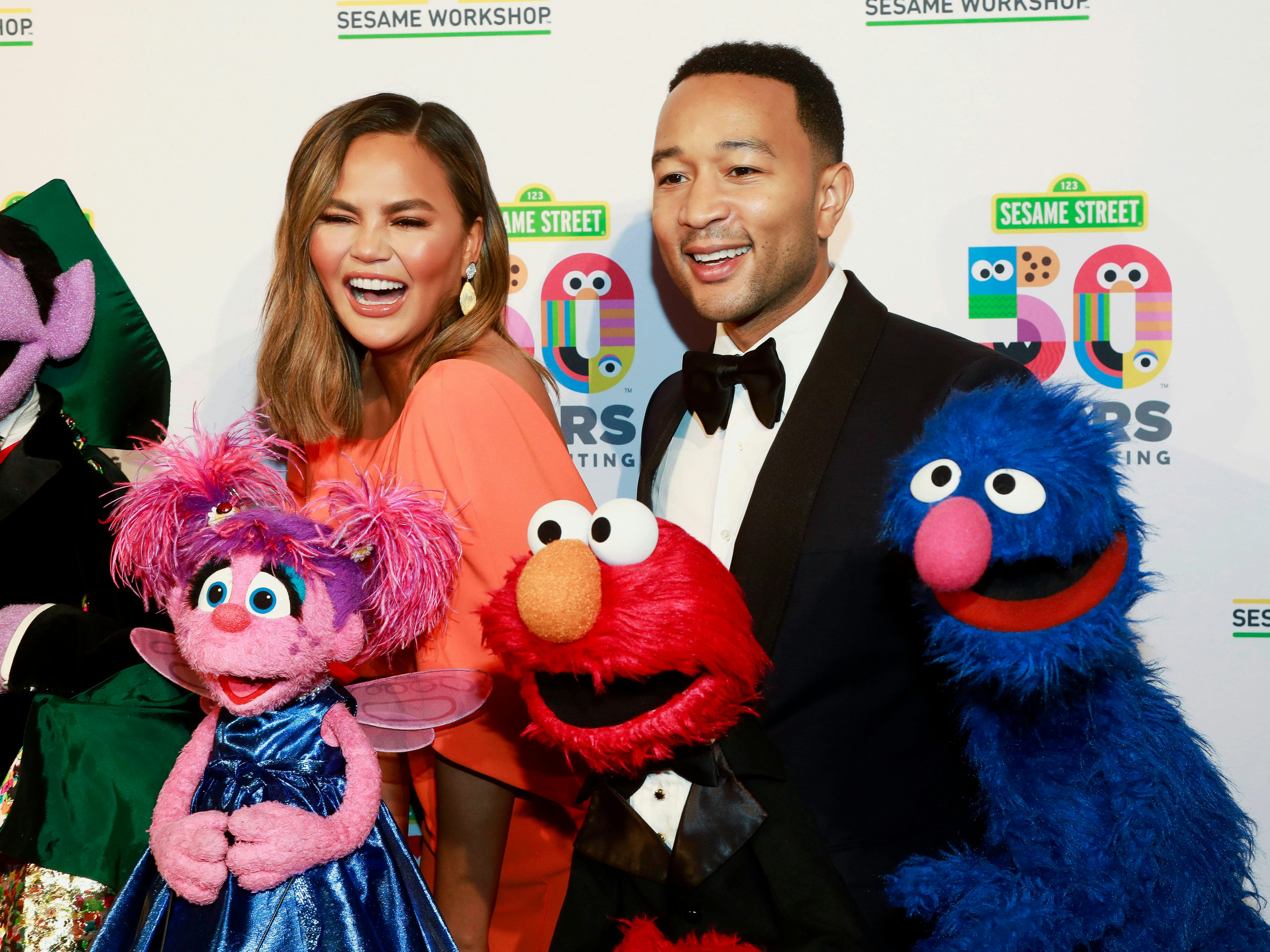 Chrissy Teigen, John Legend. Chrissy Teigen, left, and John Legend, right, attend the Sesame Worksho...