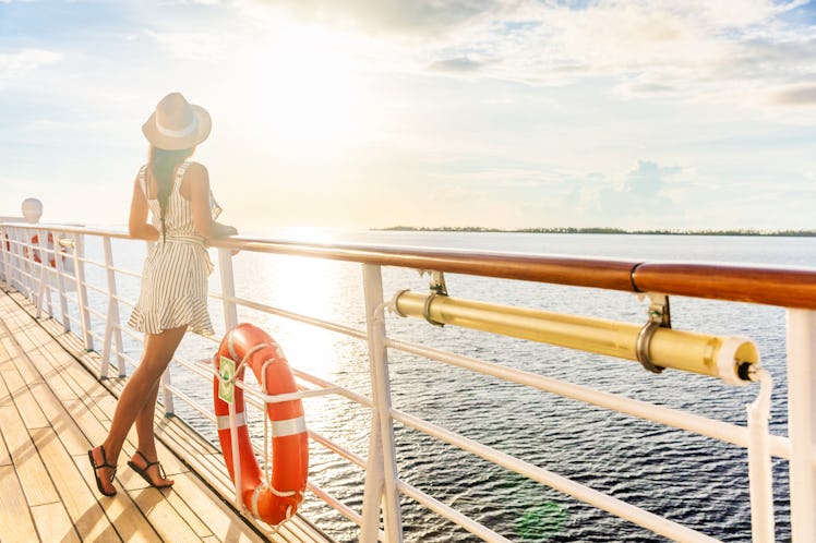 Luxury cruise ship travel elegant tourist woman watching sunset on balcony deck of Europe mediterran...