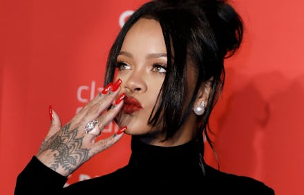 Barbadian-born singer Rihanna poses on the red carpet at the 5th Annual Diamond Ball, benefiting the...