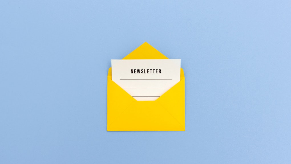 Newsletter concept - Newsletter page looking out of yellow paper envelope