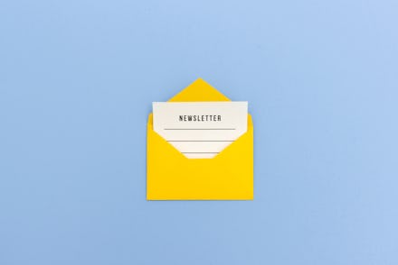Newsletter concept - Newsletter page looking out of yellow paper envelope