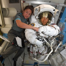 A handout photo released by NASA on 04 October 2019 shows astronauts Jessica Meir (L) and Christina ...
