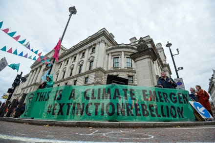 A banner erected by climate activists at a makeshift camp in Horse Guards Road outside HM Treasury, ...