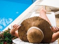 Girl sunbathes on a lounger by the pool