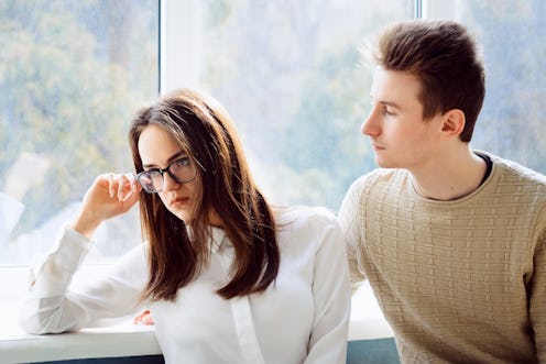 Loving boyfriend tries to cheer up his upset girlfriend student, looks and hugs her. Understanding m...