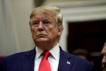 President Donald Trump listens before a trade agreement signing with Japan in the Roosevelt Room of ...