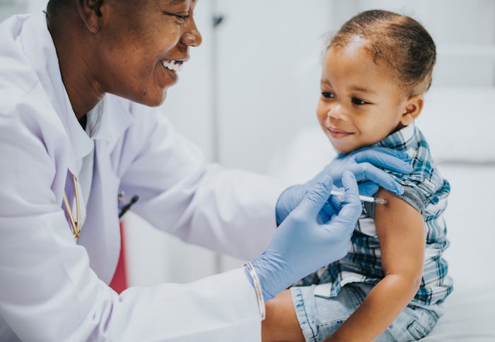 Toddler getting a vaccination by a pediatrician