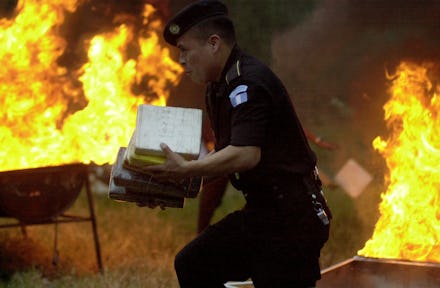 A police officer carries cocaine packages to have them burned at a police station in Guatemala City,...