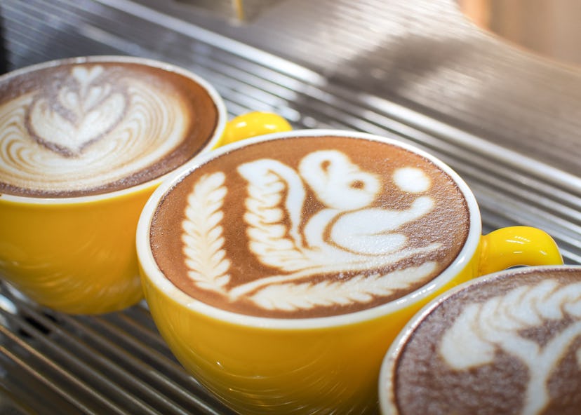 Cup of latte or cappuccino with latte art. Latte art coffee created by pouring steamed milk.