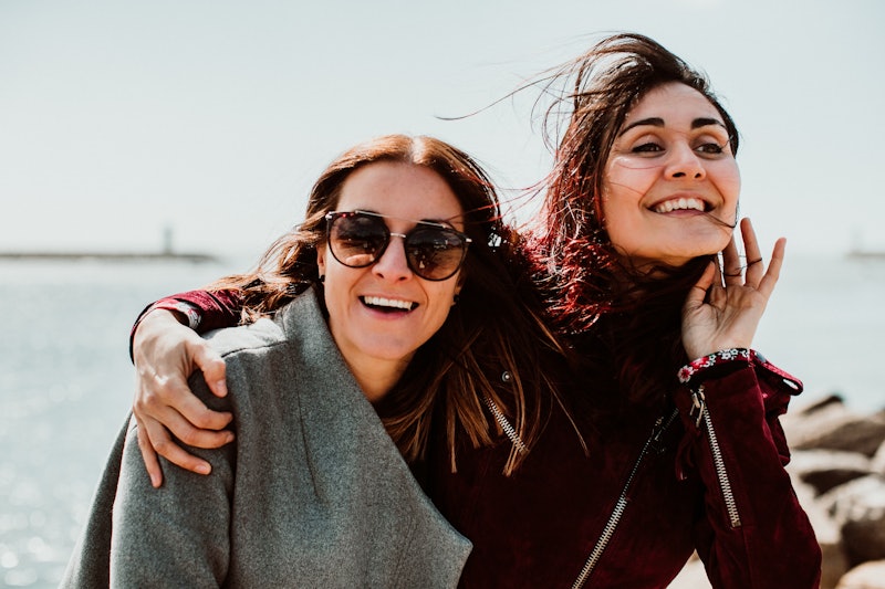 
Lesbian couple laughing together on their trip to Porto in Portugal. Walking along the coast on a w...
