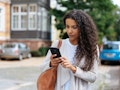 Young woman looking at phone at a text from someone who ghosted her