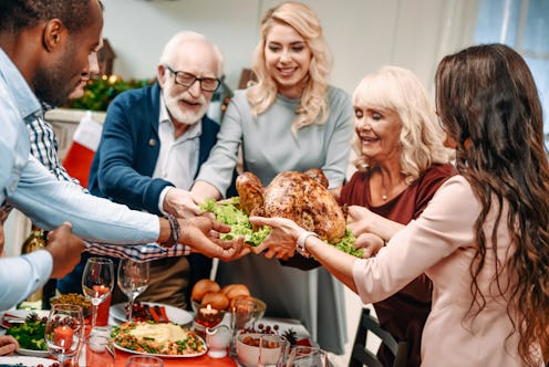 beautiful large family holding christmas turkey for holiday dinner