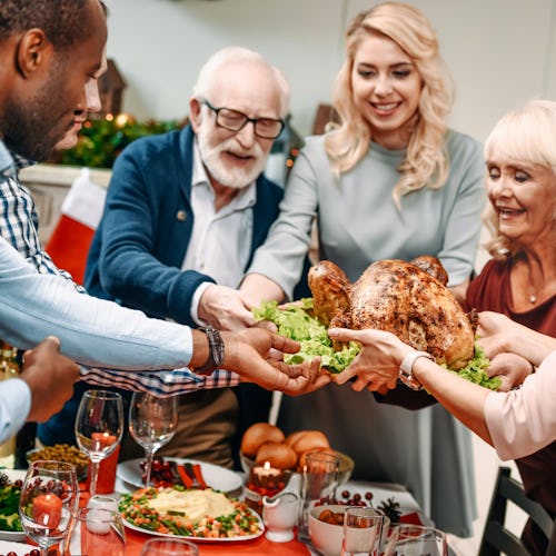 beautiful large family holding christmas turkey for holiday dinner