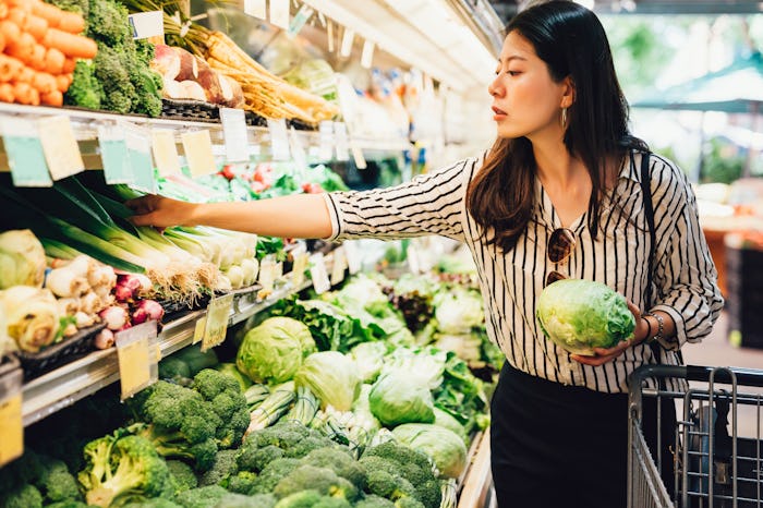 woman grocery shopping for Thanksgiving dinner