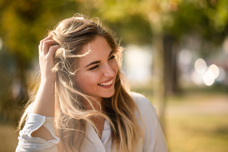 Attractive woman brushing hands through her hair