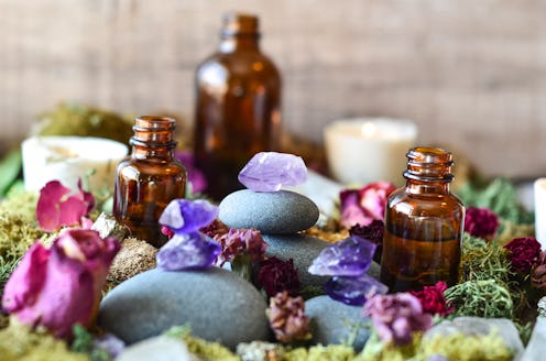 stacked crystals with oil bottles in fairy garden