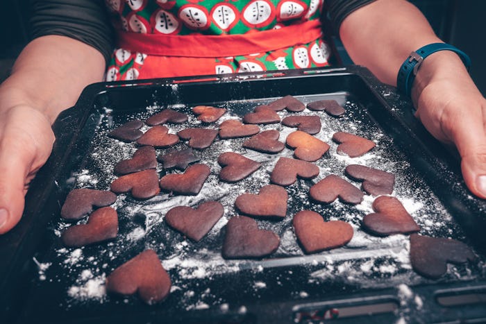 Girl holding baking tray with burnt gingerbread cookies