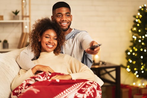 This couple cuddling under a blanket could be watching Disney+ on their Fire Stick.