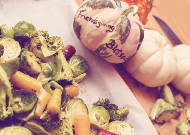 Friendsgiving Dinner preparing healthy vegetables for Thanksgiving with friends elevated view of car...