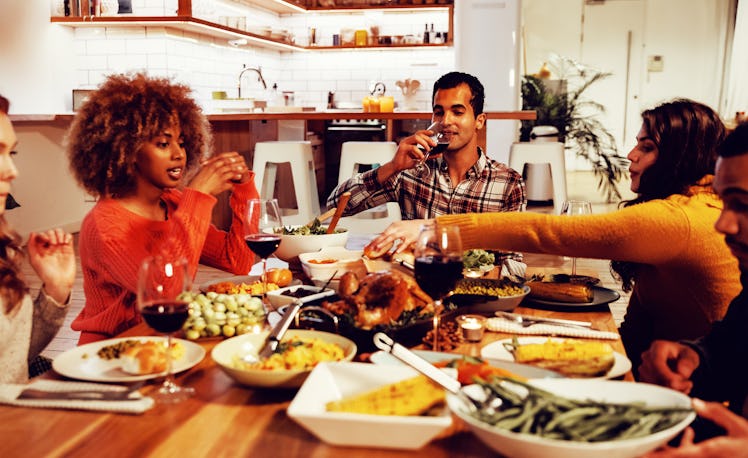 A group of friends shares a Friendsgiving dinner in their first apartment.