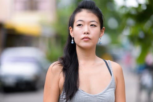 Face of beautiful Asian woman thinking and looking away
