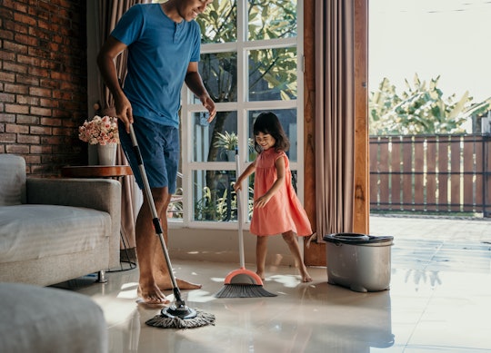 little girl help her daddy to do chores at home