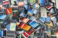 Choose mobile phone. Heap of the different smartphones with different application on the screen. Mod...