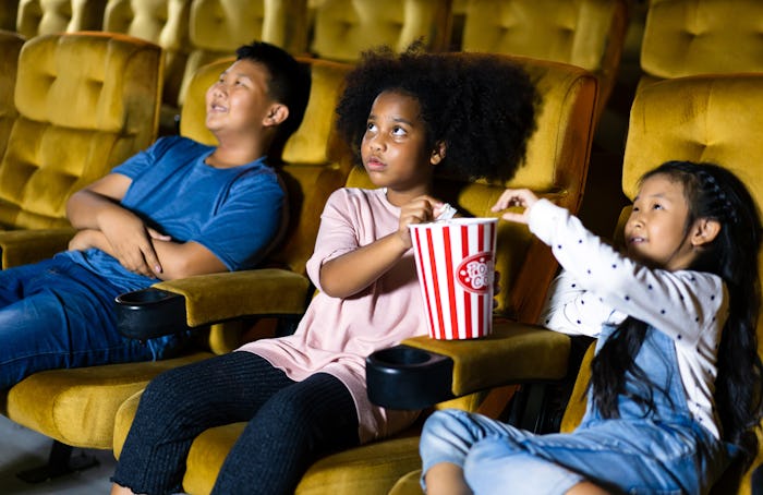 A group of kids watching a movie in a theatre