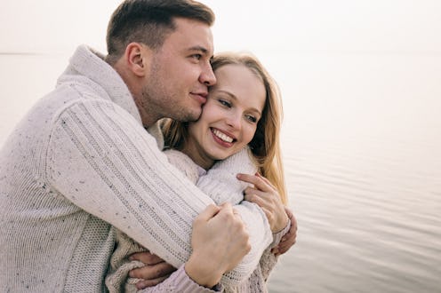 couple hugging on a pier